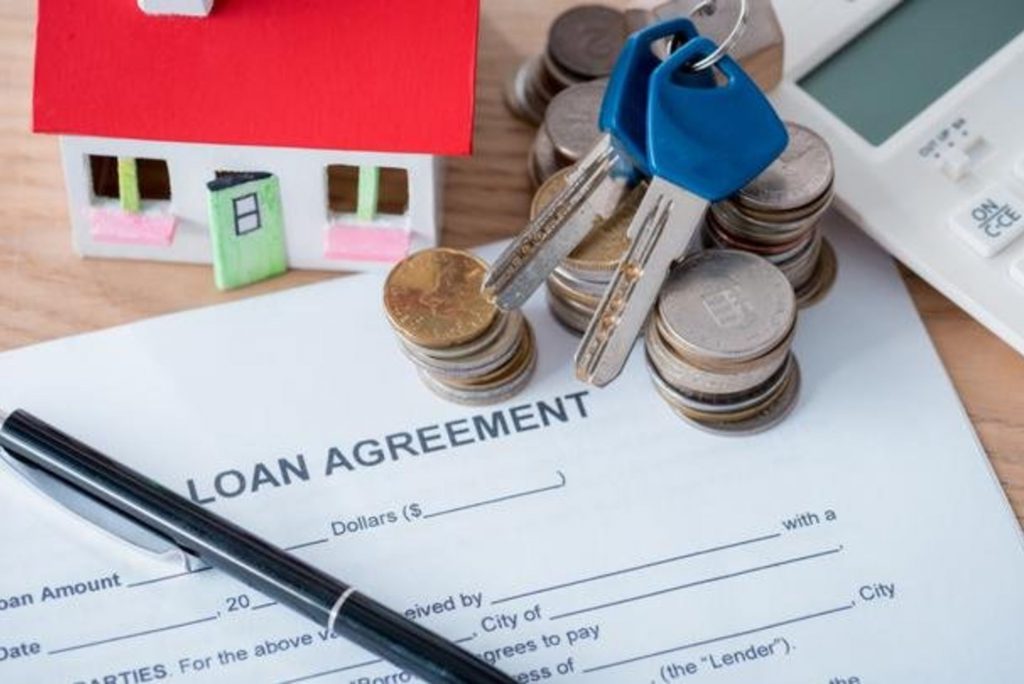 stock-photo-loan-agreement-pen-coins-house